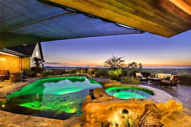 40125 Camino Del Vino, Temecula, CA 92592 - pool at dusk featuring outdoor lounge area, a patio area, and a pool with connected hot tub