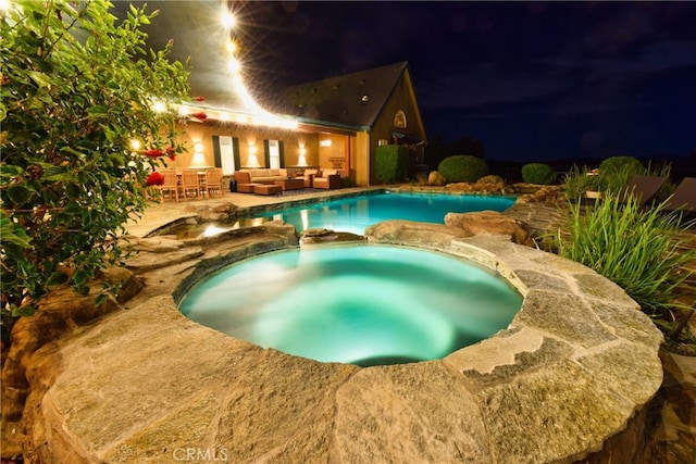 40125 Camino Del Vino, Temecula, CA 92592 - pool at night with outdoor lounge area, a pool with connected hot tub, and a patio