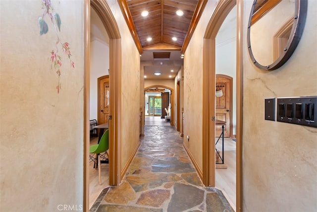 40125 Camino Del Vino, Temecula, CA 92592 - hallway featuring arched walkways, stone flooring, lofted ceiling, baseboards, and recessed lighting