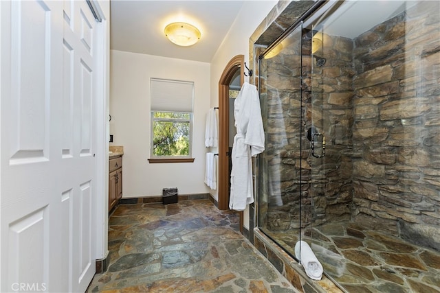 40125 Camino Del Vino, Temecula, CA 92592 - bathroom featuring stone floors, vanity, a marble finish shower, and baseboards