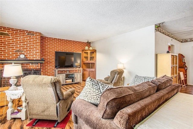 217 Syllmar Cir, Calimesa, CA 92320 - living area featuring wood finished floors, a textured ceiling, and brick wall