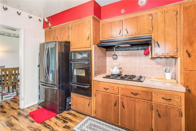 217 Syllmar Cir, Calimesa, CA 92320 - kitchen with appliances with stainless steel finishes, a warming drawer, wood finished floors, and light countertops