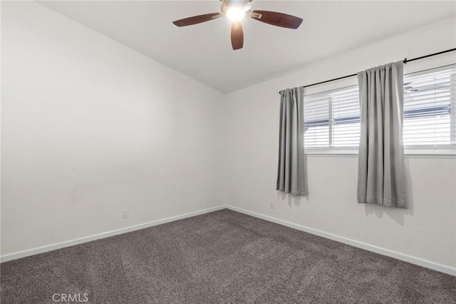 empty room featuring a ceiling fan, healthy amount of natural light, carpet flooring, and baseboards