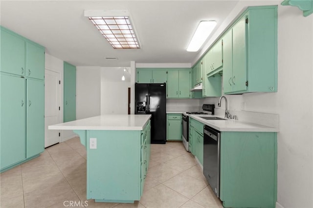 kitchen featuring black fridge, a sink, gas range, stainless steel dishwasher, and a center island