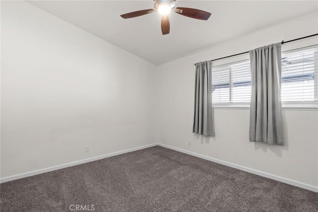 spare room with a ceiling fan, carpet flooring, healthy amount of natural light, and baseboards