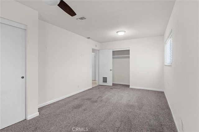 unfurnished bedroom featuring carpet floors, baseboards, and a ceiling fan