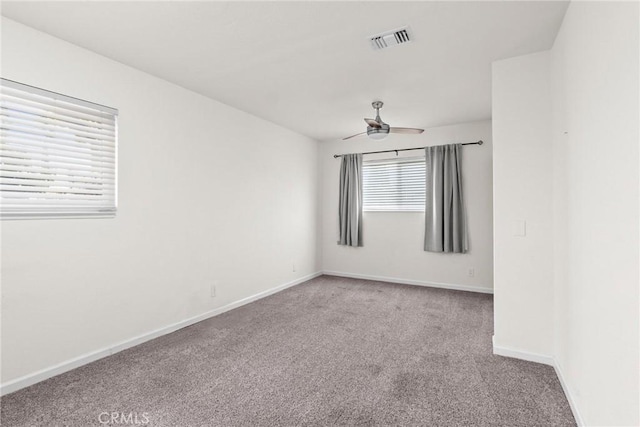 spare room with carpet flooring, ceiling fan, and baseboards