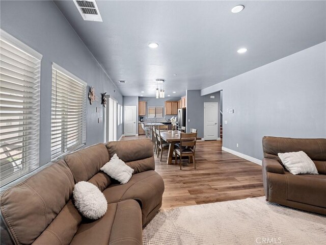 10630 Appaloosa Ave, Hesperia, CA 92345 - living room featuring recessed lighting, light wood finished floors, healthy amount of natural light, and baseboards