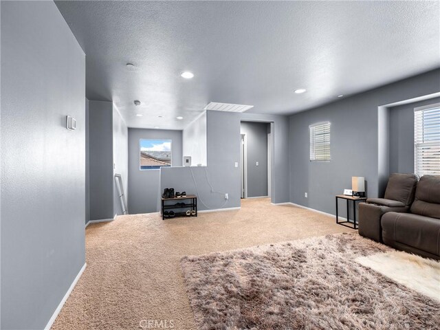 10630 Appaloosa Ave, Hesperia, CA 92345 - carpeted living area featuring baseboards, healthy amount of natural light, recessed lighting, and a textured ceiling