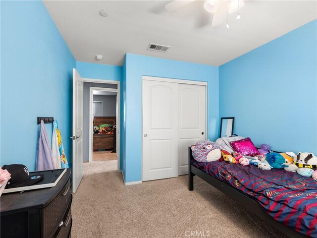 10630 Appaloosa Ave, Hesperia, CA 92345 - bedroom with light carpet, a closet, ceiling fan, and baseboards