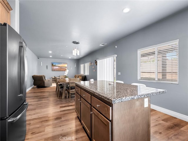 10630 Appaloosa Ave, Hesperia, CA 92345 - kitchen featuring freestanding refrigerator, light wood-style floors, light stone countertops, recessed lighting, and baseboards