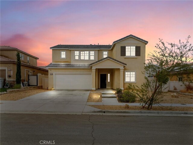 10630 Appaloosa Ave, Hesperia, CA 92345 - traditional-style house featuring stucco siding, driveway, a garage, and fence