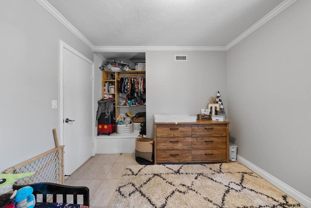 bedroom featuring ornamental molding, a closet, and light tile patterned floors