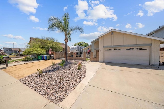 view of front of home featuring driveway, fence, board and batten siding, and a garage
