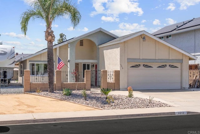 view of front of home featuring concrete driveway, a garage, a fenced front yard, and stucco siding