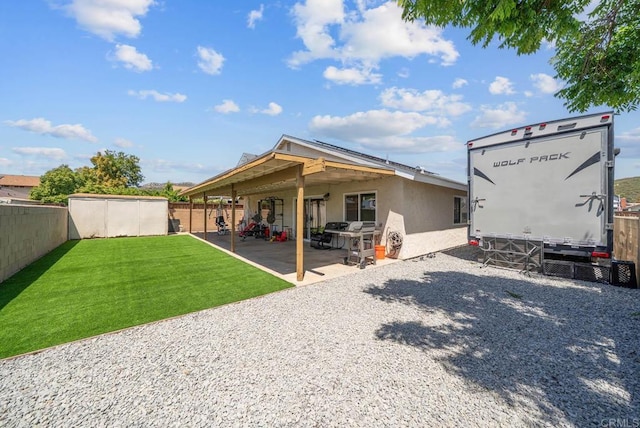 back of house with a patio area and stucco siding
