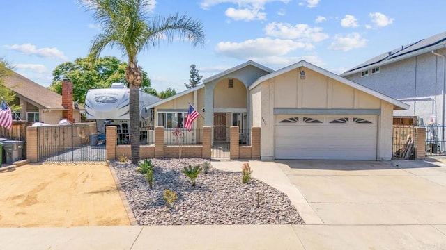 view of front of home with a gate, concrete driveway, a garage, and a fenced front yard