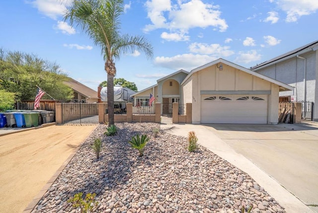 ranch-style house featuring a gate, concrete driveway, and a fenced front yard
