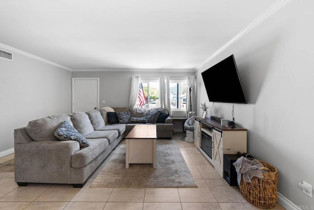 living room with crown molding, light tile patterned flooring, and baseboards