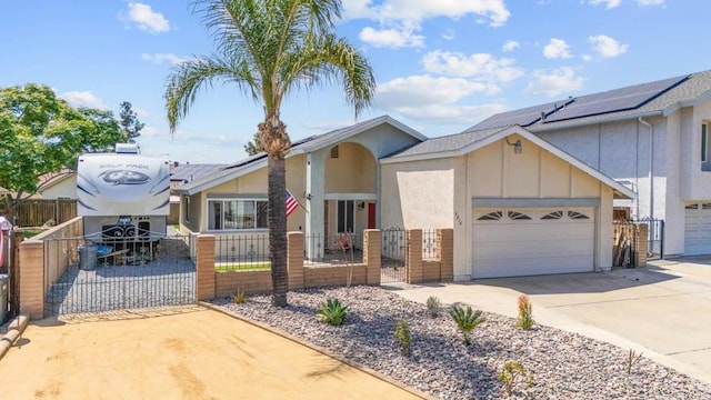 view of front of property featuring driveway, board and batten siding, a fenced front yard, a gate, and a garage