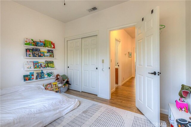 1918 Potter Rd, Chico, CA 95928 - bedroom featuring light wood finished floors, baseboards, and a closet