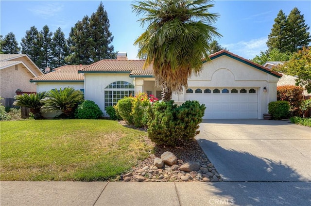 1918 Potter Rd, Chico, CA 95928 - mediterranean / spanish-style home featuring a tiled roof, a chimney, a front yard, an attached garage, and concrete driveway