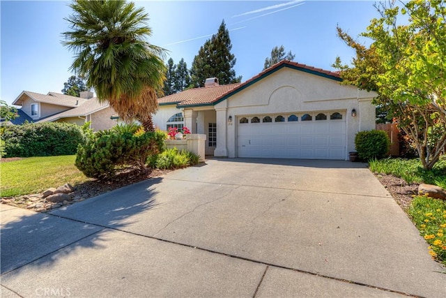 1918 Potter Rd, Chico, CA 95928 - mediterranean / spanish home with a garage, stucco siding, driveway, a chimney, and a tiled roof