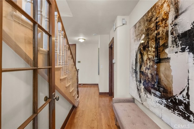 1156 E Howard St, Pasadena, CA 91104 - hallway with light wood finished floors, stairway, and baseboards