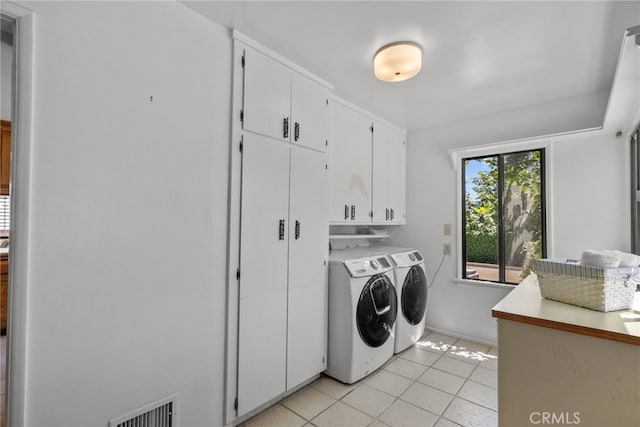 1156 E Howard St, Pasadena, CA 91104 - washroom featuring cabinet space, separate washer and dryer, and light tile patterned floors