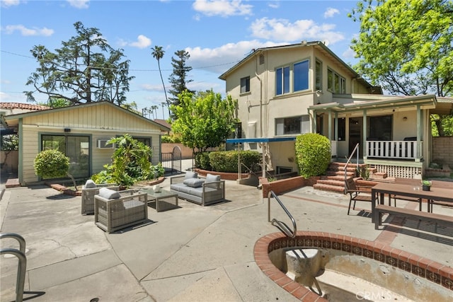 1156 E Howard St, Pasadena, CA 91104 - rear view of property featuring a patio, outdoor lounge area, and covered porch