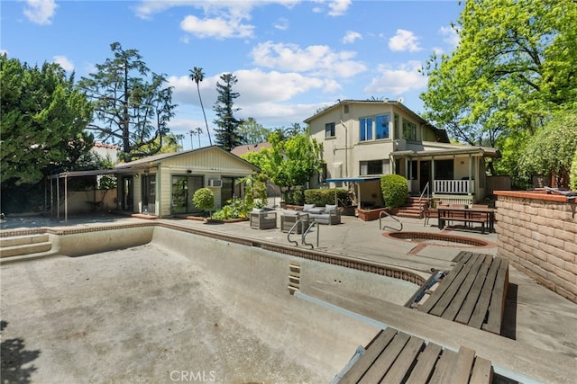 1156 E Howard St, Pasadena, CA 91104 - rear view of house with a patio, an outdoor structure, and an empty pool