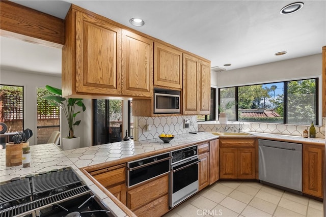1156 E Howard St, Pasadena, CA 91104 - kitchen featuring stainless steel appliances, a sink, tile countertops, tasteful backsplash, and recessed lighting