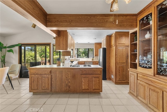 1156 E Howard St, Pasadena, CA 91104 - kitchen with stainless steel appliances, light countertops, a peninsula, brown cabinets, and light tile patterned floors