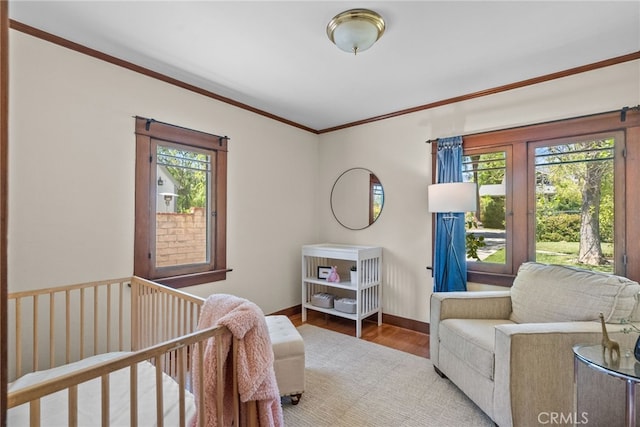 1156 E Howard St, Pasadena, CA 91104 - bedroom featuring multiple windows, ornamental molding, wood finished floors, baseboards, and a nursery area