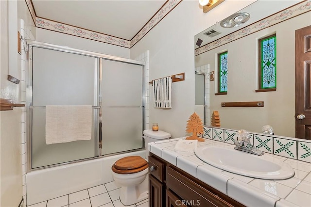 27657 Peninsula Dr, Lake Arrowhead, CA 92352 - full bath with toilet, shower / bath combination with glass door, vanity, and tile patterned flooring