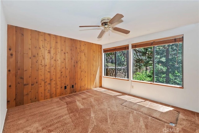 27657 Peninsula Dr, Lake Arrowhead, CA 92352 - unfurnished room with wooden walls, a ceiling fan, and carpet