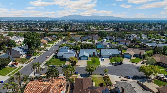 aerial overview of property's location featuring a mountainous background and nearby suburban area