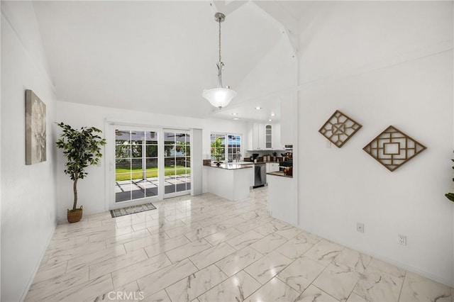 living room with light marble finish flooring, high vaulted ceiling, and baseboards
