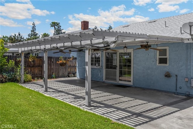 rear view of house featuring a pergola, a ceiling fan, a patio, a chimney, and stucco siding
