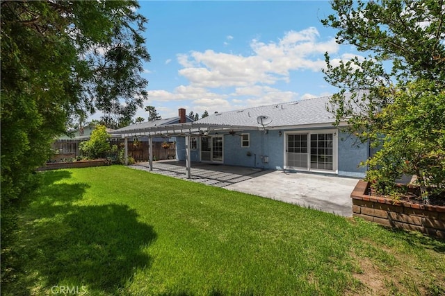 rear view of property with a pergola, stucco siding, a patio area, and a chimney