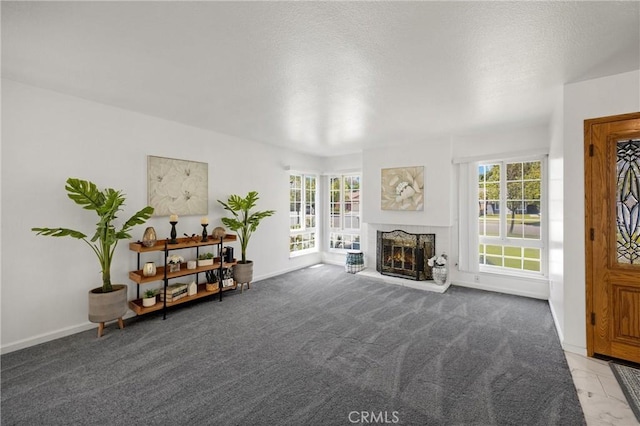 sitting room with plenty of natural light, a fireplace, and light colored carpet
