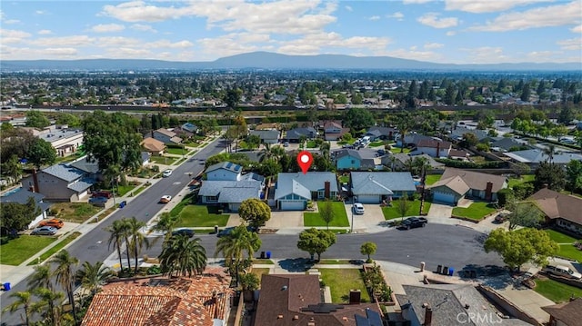 view of property location with mountains and nearby suburban area