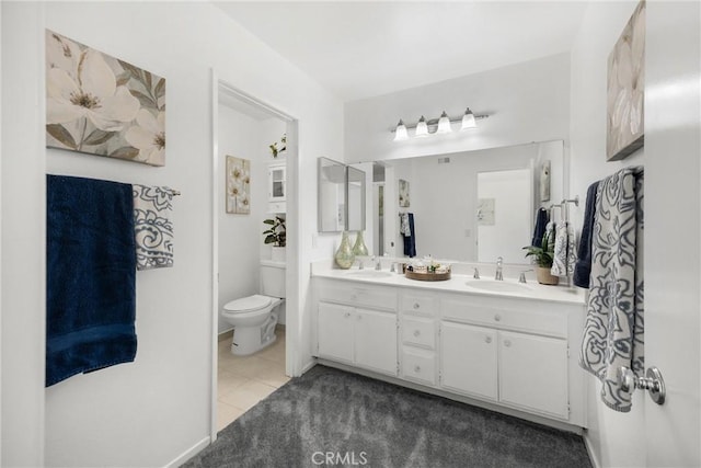 bathroom featuring double vanity, toilet, and tile patterned floors