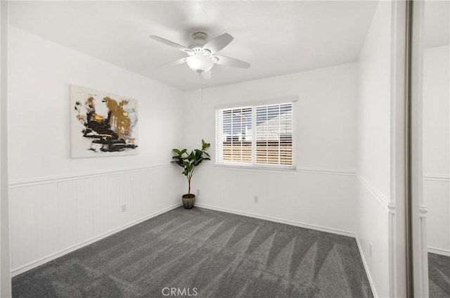 empty room with carpet flooring and a ceiling fan