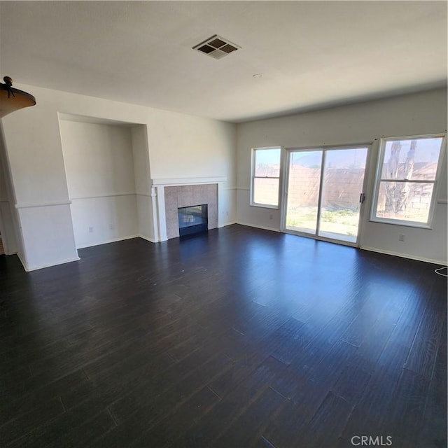 4542 Kalpesh Ct, Hemet, CA 92544 - unfurnished living room with a tiled fireplace, dark wood finished floors, and baseboards