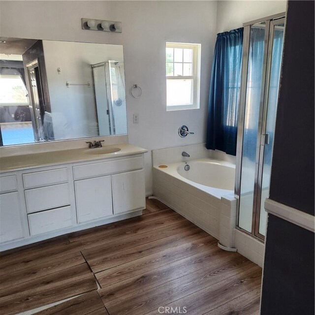 4542 Kalpesh Ct, Hemet, CA 92544 - full bath featuring a stall shower, a bath, vanity, and wood finished floors