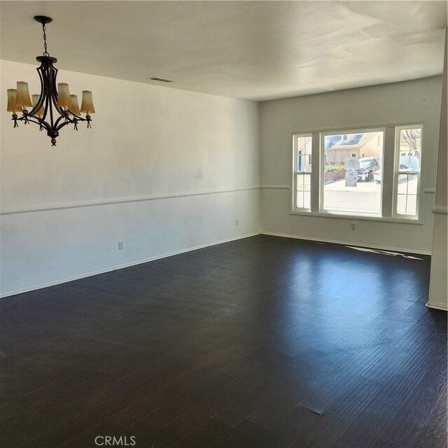 4542 Kalpesh Ct, Hemet, CA 92544 - spare room with dark wood-style floors, a chandelier, and baseboards