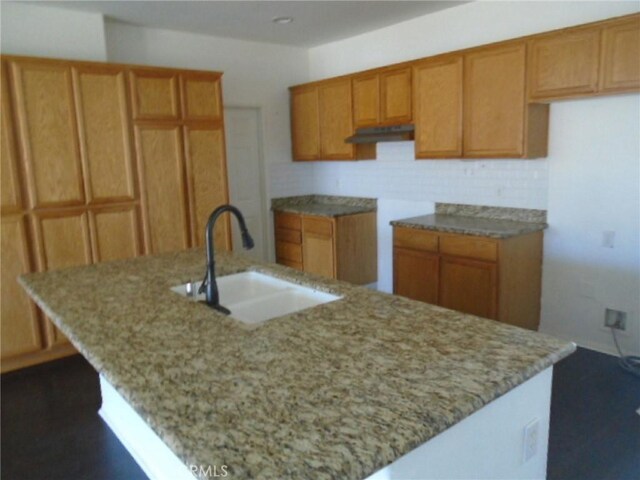 4542 Kalpesh Ct, Hemet, CA 92544 - kitchen with a sink, light stone counters, a center island with sink, and backsplash