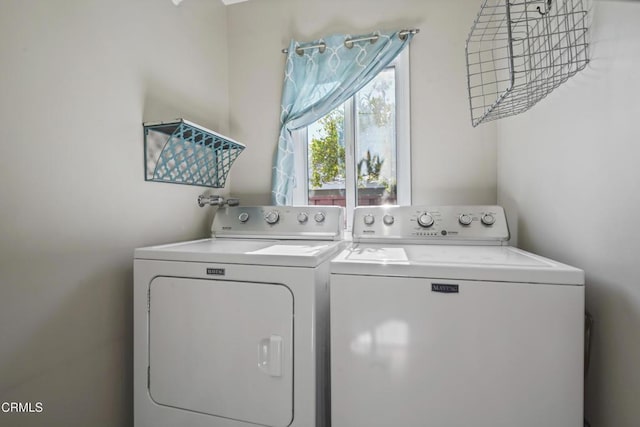 clothes washing area featuring washer and clothes dryer