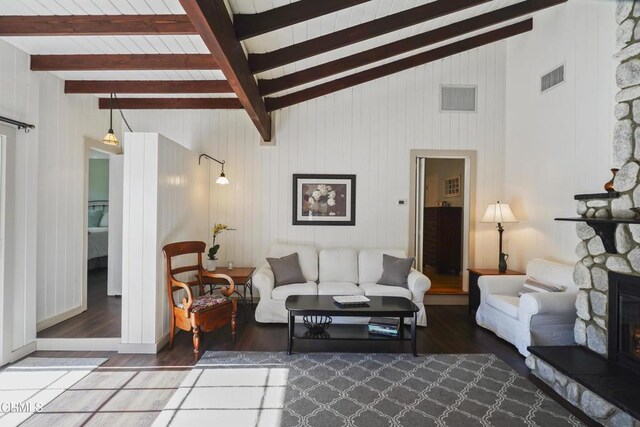 living area with wood finished floors and a stone fireplace
